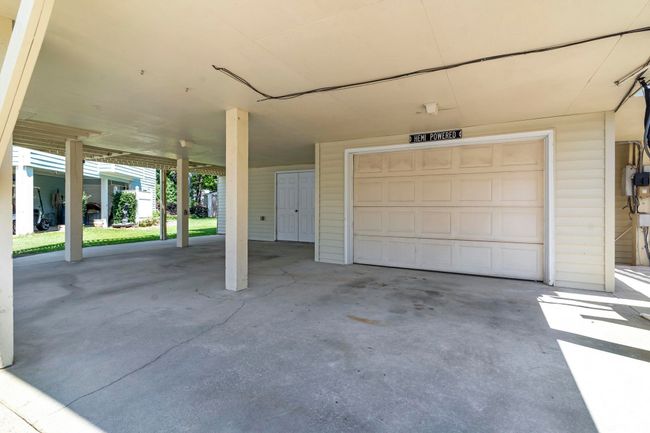 Garage with a carport | Image 7