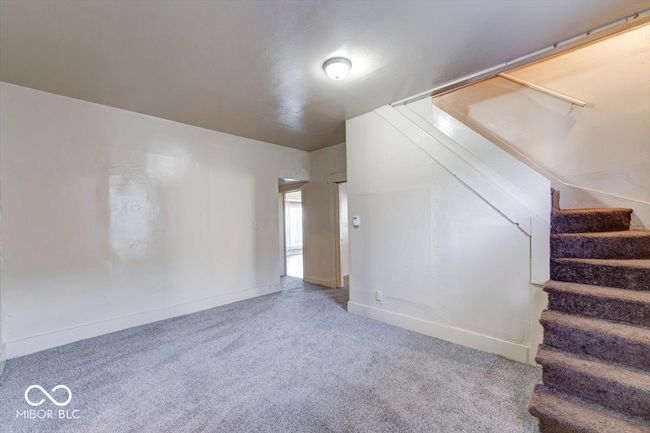 interior space with carpet, baseboards, and stairs | Image 10
