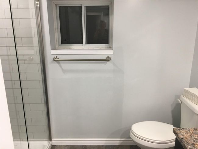 Full bathroom with a shower stall, baseboards, and toilet | Image 24