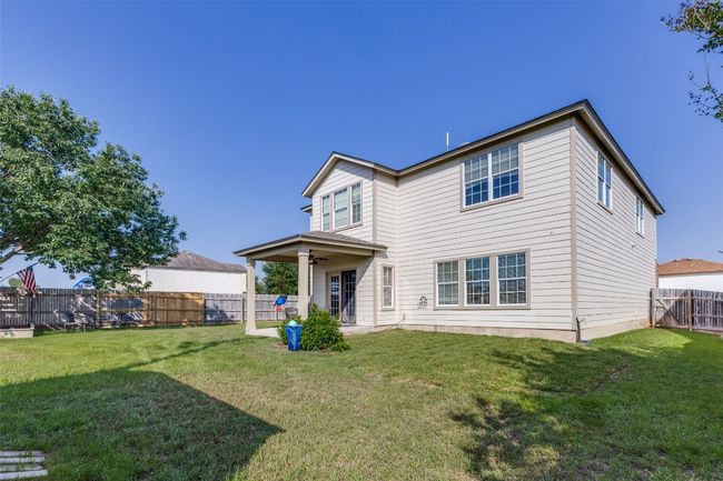 Rear view of house featuring ceiling fan and a patio area | Image 36