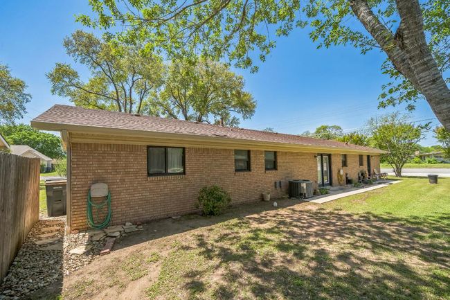 Back of house, fence, central AC unit, and a lawn | Image 5