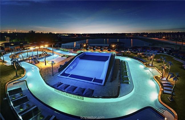 Community pool with a water play area and a hot tub | Image 23