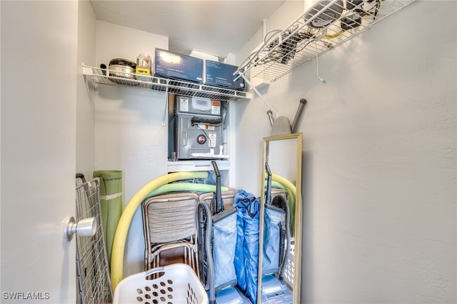 View of guest bedroom walk-in closet w/ new HVAC unit and HWH. | Image 12