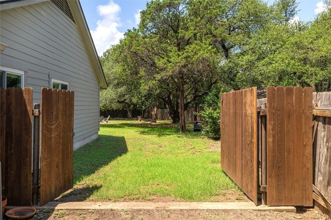 Side gate opens to allow easy access to backyard and shed. | Image 34