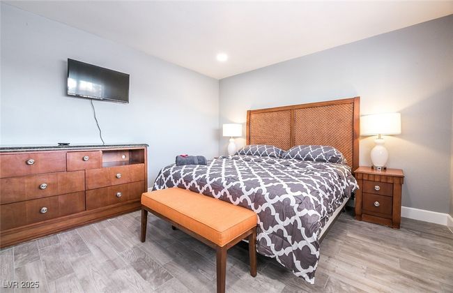 Bedroom with light wood-style floors and baseboards | Image 42