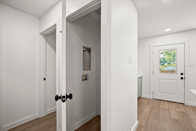 Hallway with light wood-style flooring and baseboards | Image 20