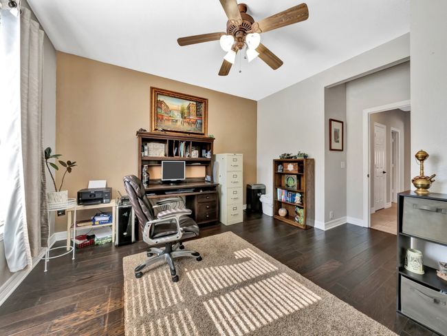 Home office with ceiling fan, hardwood floors, and baseboards | Image 29