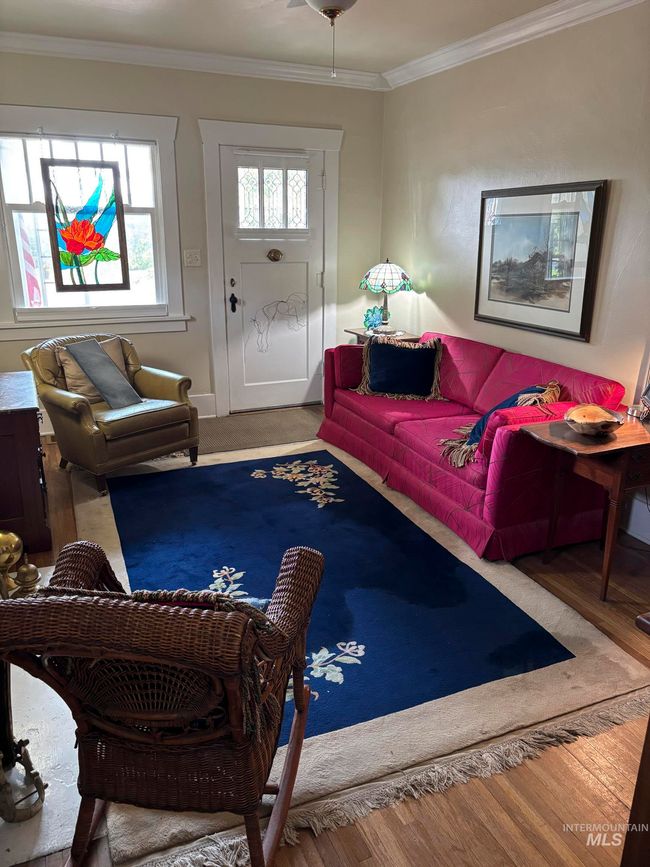 Living room featuring crown molding and wood finished floors | Image 8