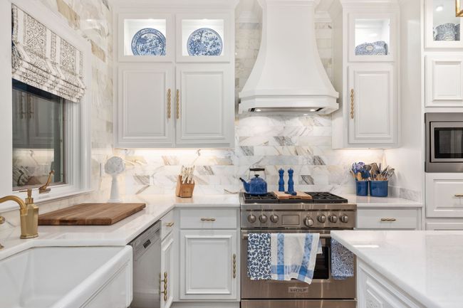 Wolf Gas Range, Quartz counters, gold finished faucet and cabinet handles | Image 15