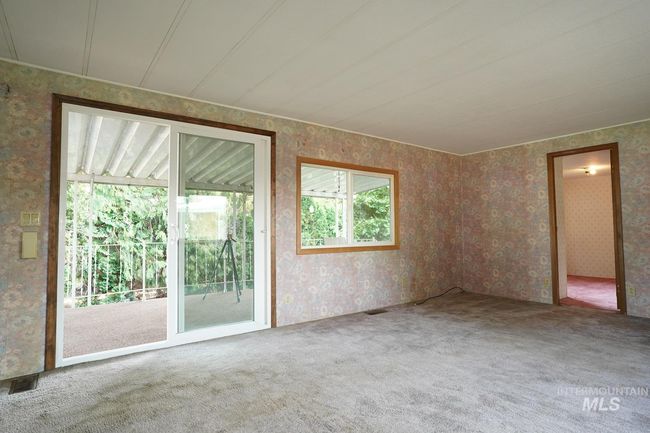Carpeted empty room featuring wallpapered walls | Image 7