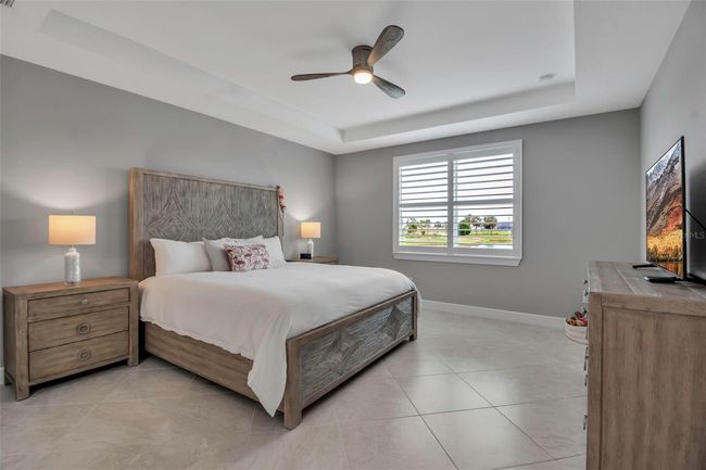 Back inside to the Primary suite with Coffered ceiling and plantation shutters | Image 32