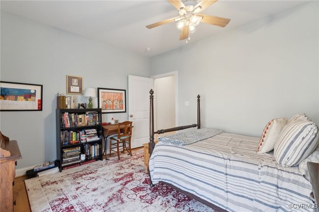 Bedroom featuring ceiling fan, baseboards, and wood finished floors | Image 27