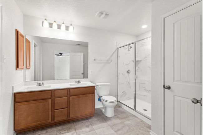 Primary bathroom with dual vanity and walk-in shower | Image 19