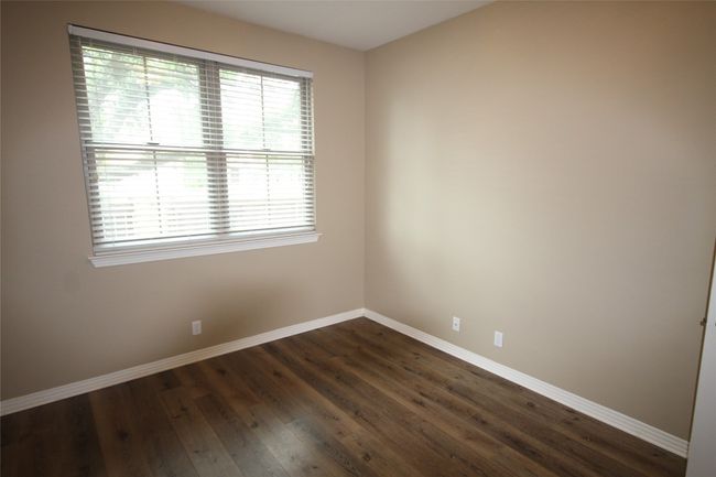 Spare room with baseboards and dark wood-style flooring | Image 11