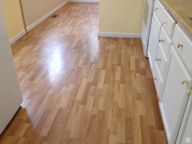 Kitchen with laminate flooring. | Image 22