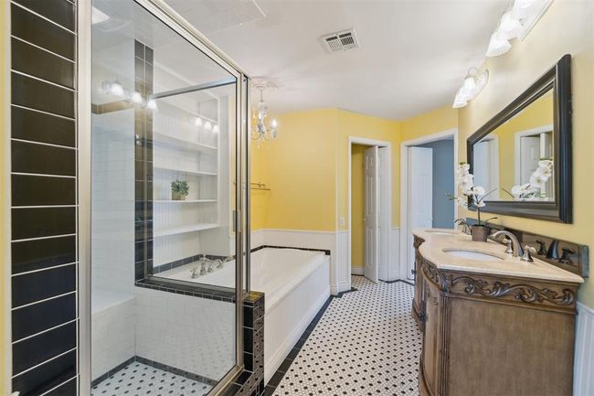Bathroom featuring a stall shower, a bath, double vanity, and tile patterned floors | Image 22