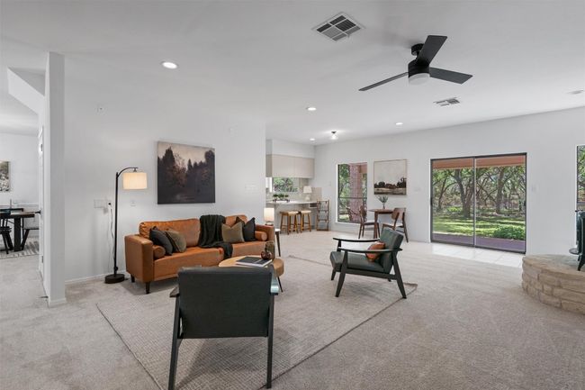 Living area with a ceiling fan, visible vents, recessed lighting, and light colored carpet | Image 8