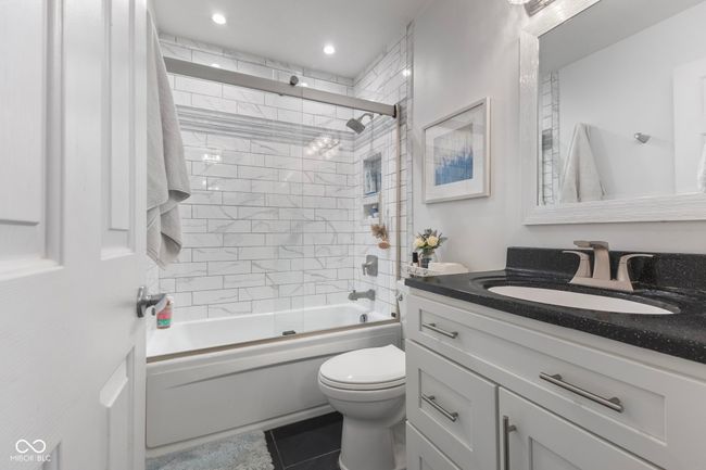 bathroom with vanity, tile patterned flooring, enclosed tub / shower combo, and recessed lighting | Image 18