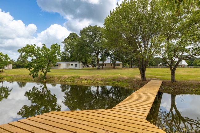 Tranquil retreat featuring a charming wooden pier, perfect for relaxation and enjoying serene views. | Image 40