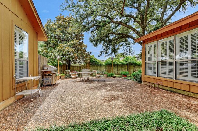 Fenced backyard featuring grilling area, a patio area, and outdoor dining space | Image 37