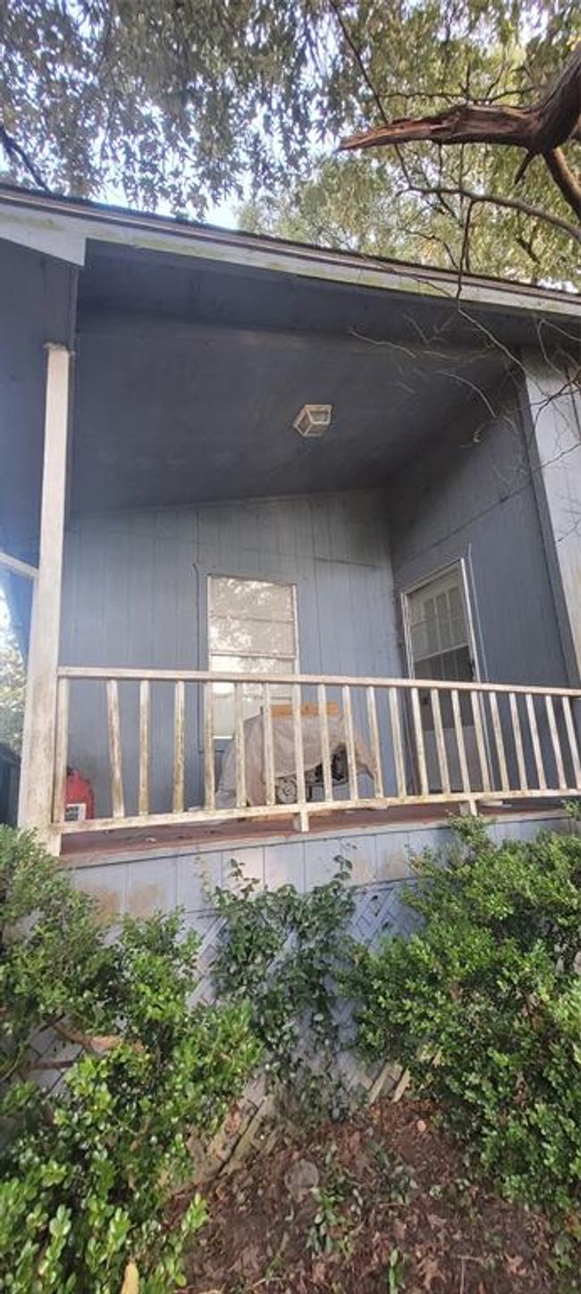 Unique front porch sitting area. | Image 7