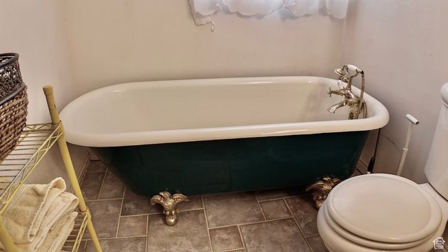 Bathroom featuring toilet and a freestanding bath | Image 46