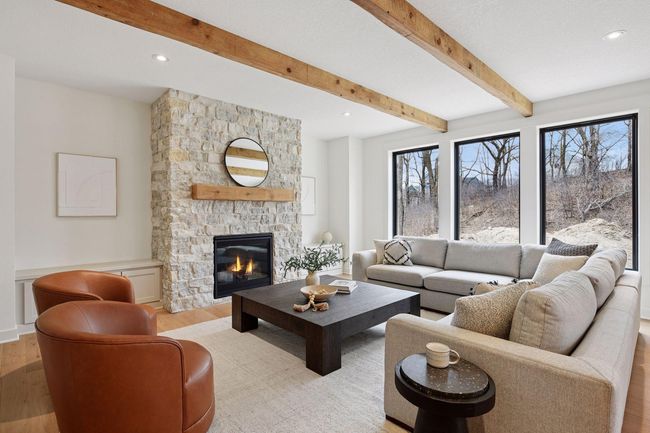 Spacious, main level family room with floor to ceiling stone fireplace. | Image 4