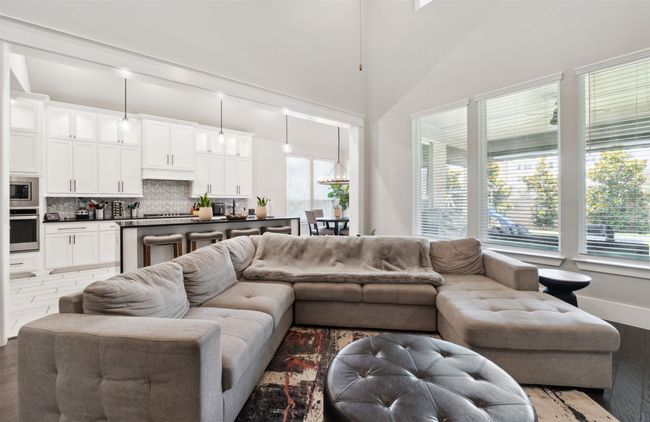 Living room featuring wood finished floors and a towering ceiling | Image 9