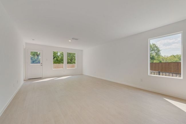 Spare room featuring light wood finished floors and healthy amount of natural light | Image 6