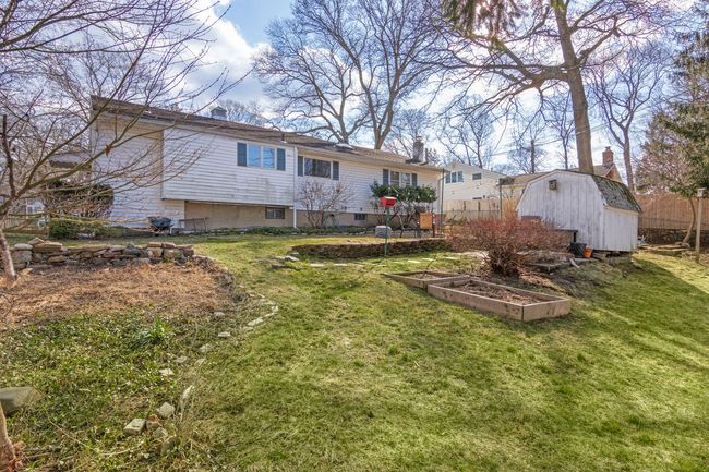Back of house, landscaped with a storage shed, a lawn, and fully fenced | Image 23