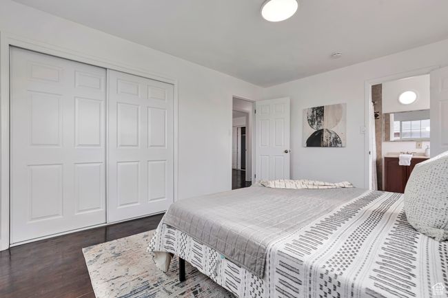 Bedroom featuring a closet and wood finished floors | Image 4