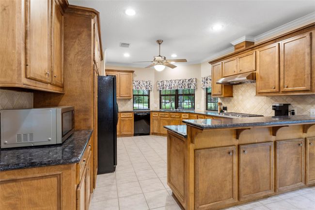 Tons of solid wood cabinets, could be easily painted to match your style or leave this stained rustic look. | Image 13