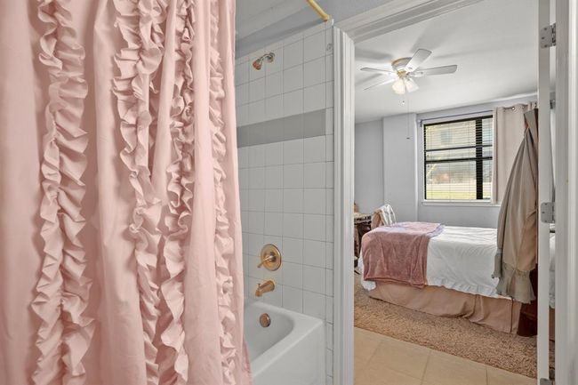 Bathroom with ensuite bath, shower / tub combo, a ceiling fan, and tile patterned​​‌​​​​‌​​‌‌​‌‌​​​‌‌​​‌‌​‌​​​​​‌ flooring | Image 18