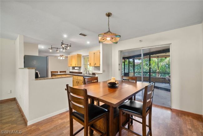 Dining area with rail lighting and hardwood / wood-style flooring | Image 7