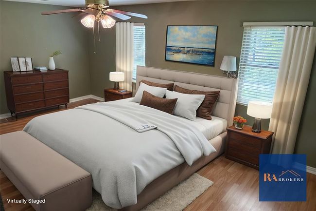 Spacious primary bedroom with two new double-pane windows for enhanced comfort. (Virtually staged) | Image 4
