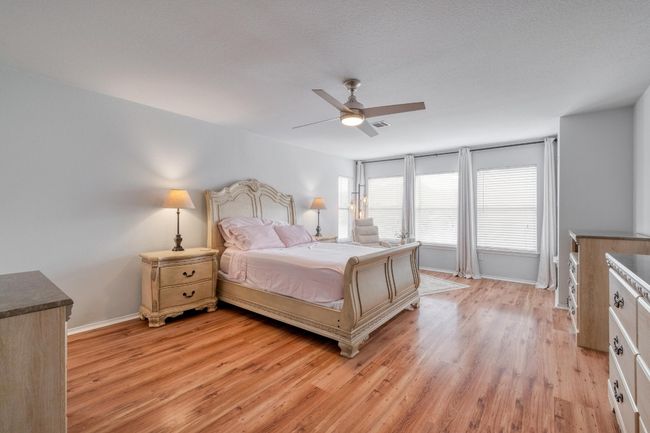 Bedroom featuring light wood-type flooring and ceiling fan | Image 19