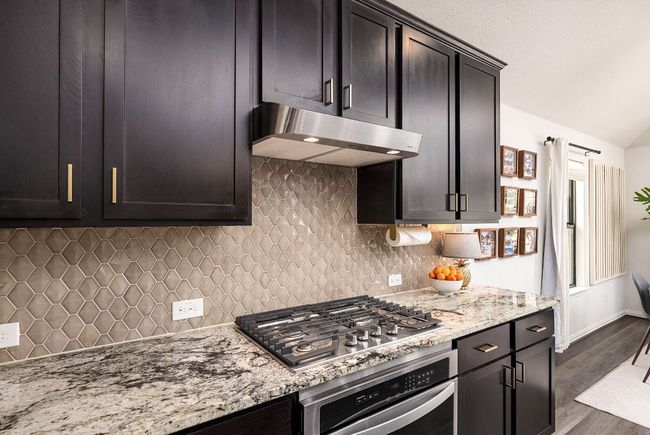 An upgraded under cabinet range hood and gas stove | Image 4