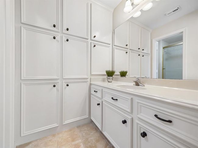 Elegant Jack and Jill bathroom seamlessly links the second and third bedrooms. | Image 44