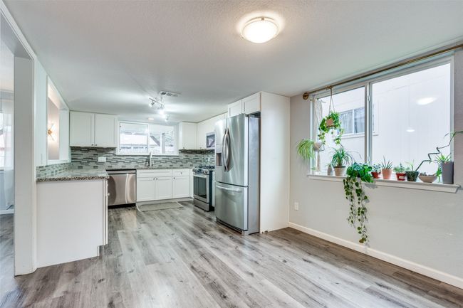 Kitchen featuring sink, white cabinetry, appliances with stainless steel finishes, and tasteful backsplash | Image 14