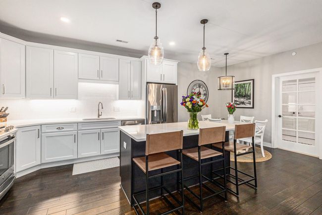 Kitchen island with view of laundry room with updated doors | Image 22
