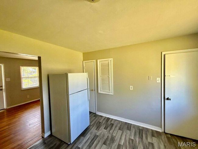 Kitchen with freestanding refrigerator, dark wood-style floors, and baseboards | Image 10