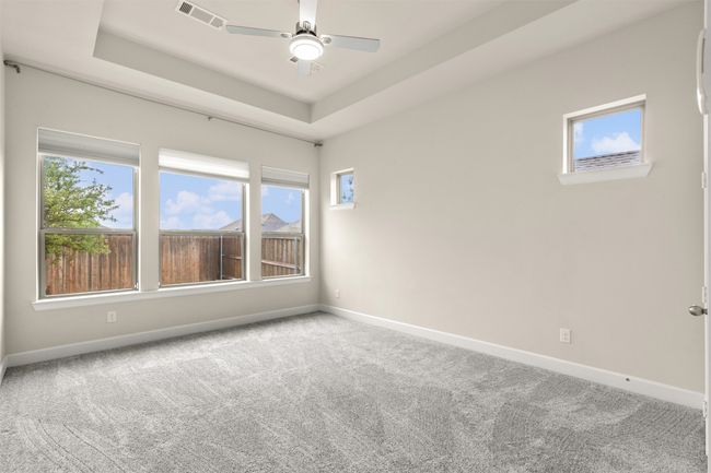 Master bedroom room with carpet floors, baseboards, and plenty of natural light | Image 18