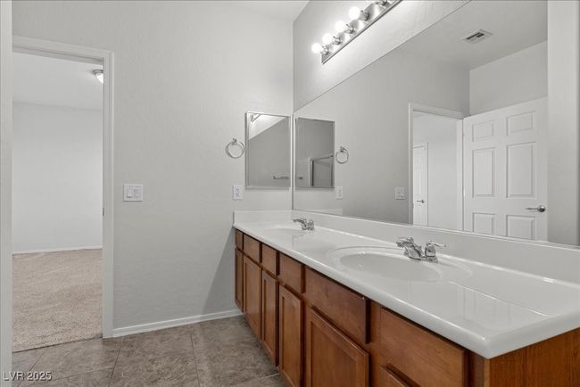 Full bath with double vanity and tile patterned floors | Image 37