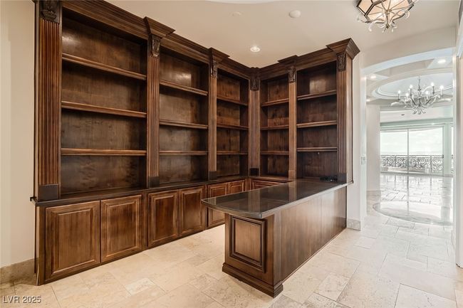 Unfurnished office with a chandelier, stone tile flooring, recessed lighting, and baseboards | Image 16