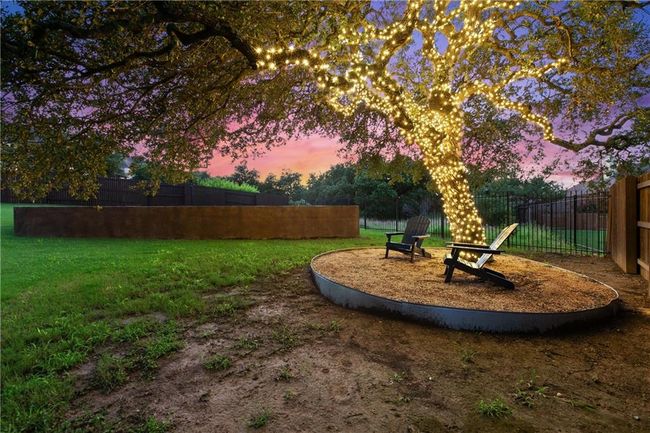 Large oak tree with sitting area in backyard. | Image 31