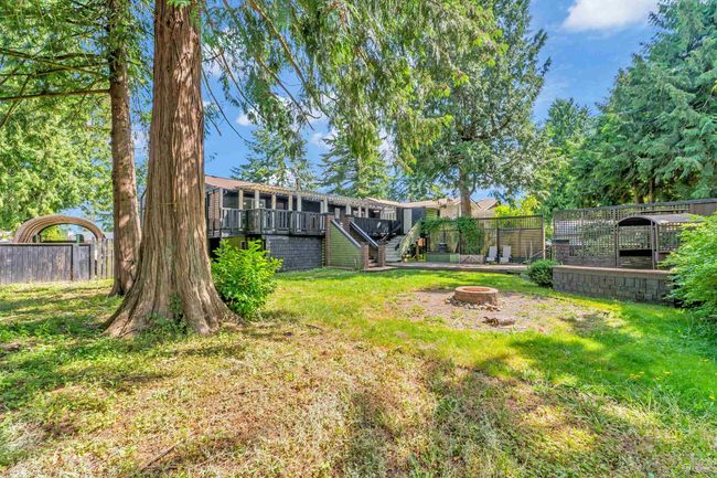 View of yard with a fire pit, fence, a deck, and stairs | Image 35
