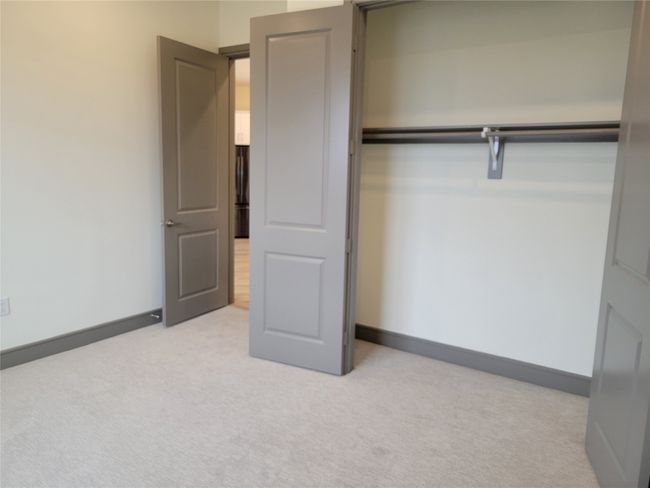 Unfurnished bedroom featuring light carpet and a closet | Image 15