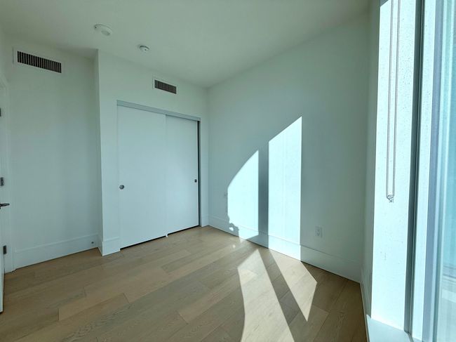 Unfurnished bedroom with baseboards, visible vents, a closet, and light wood-type flooring | Image 11