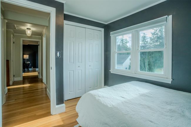 Bedroom with hardwood / wood-style flooring, a closet, and crown molding | Image 16
