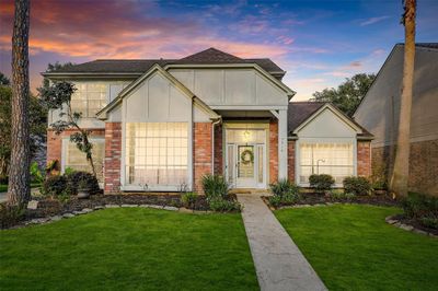 Lovely elevation that welcomes with a large entry and tons of windows! | Image 1